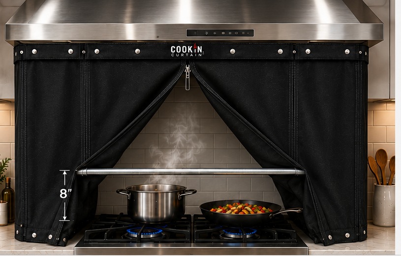 Cookin Curtain attached beneath a stainless steel range hood with one flap pulled back and a crossbar above the cooktop
